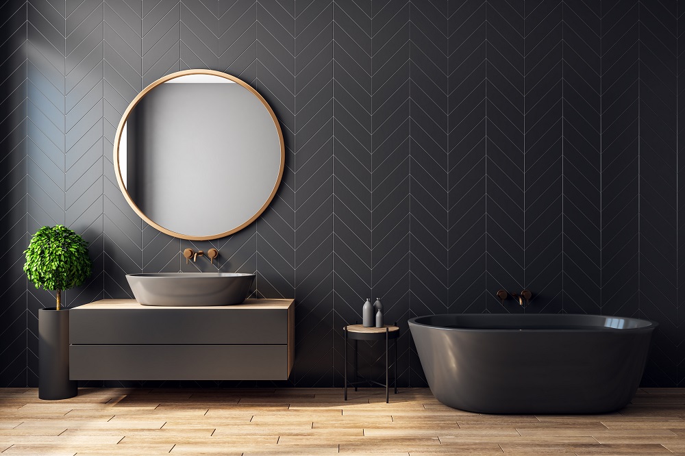 Modern black bathroom interior with decorative tree, bath tub, sink, round mirror, sunlight and copy space. 3D Rendering